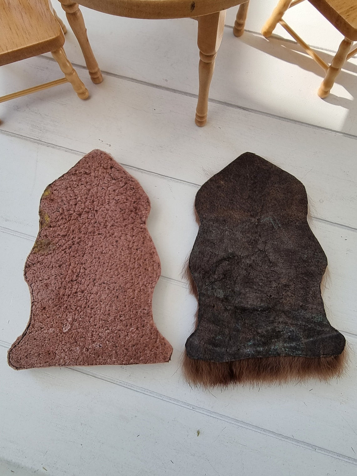Image shows the back detail of 2 brown 1:12 scale animal skin genuine fur rugs.